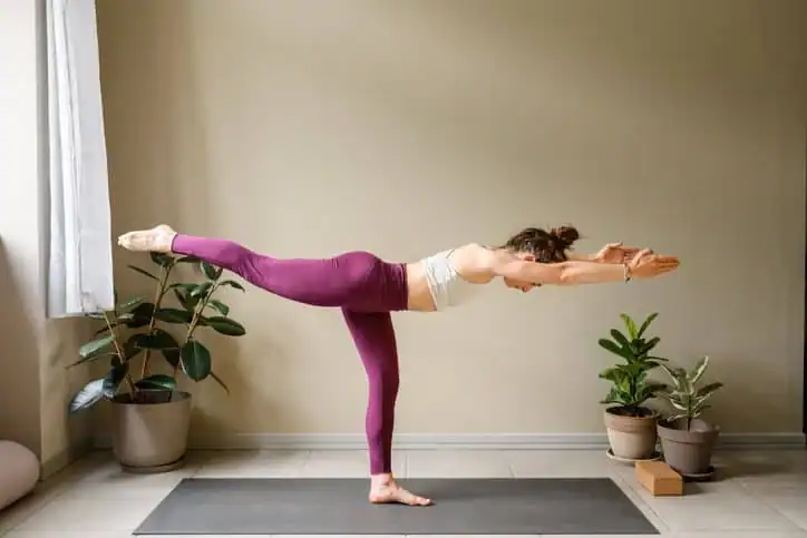 Woman doing Yoga exercise Peterborough to help with toning the body. 